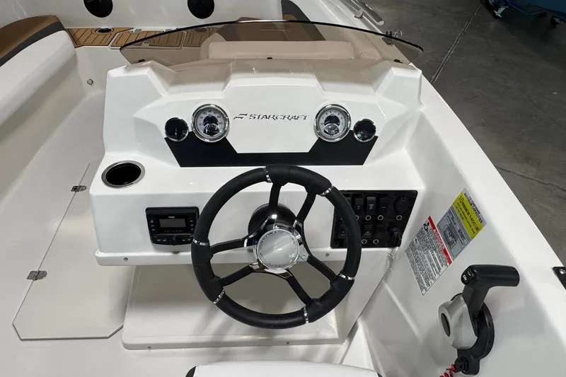 Slide: The Image of 2025 Starcraft SVX 171 OB boat dashboard with steering wheel and control panel. - 11