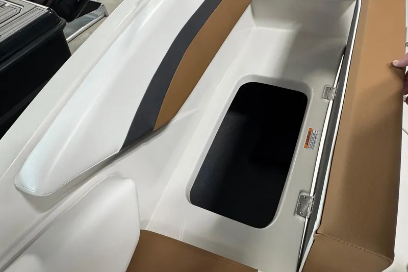 Slide: The Image of 2025 Starcraft SVX 171 OB boat storage compartment with open lid, showcasing interior space. - 12