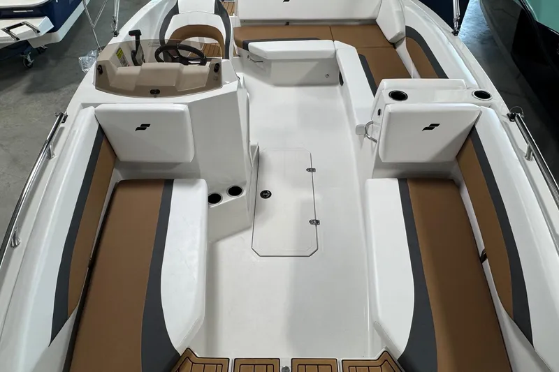 Slide: The Image of 2025 Starcraft SVX 171 OB boat interior with brown and gray seating, steering wheel, and cup holders. - 6