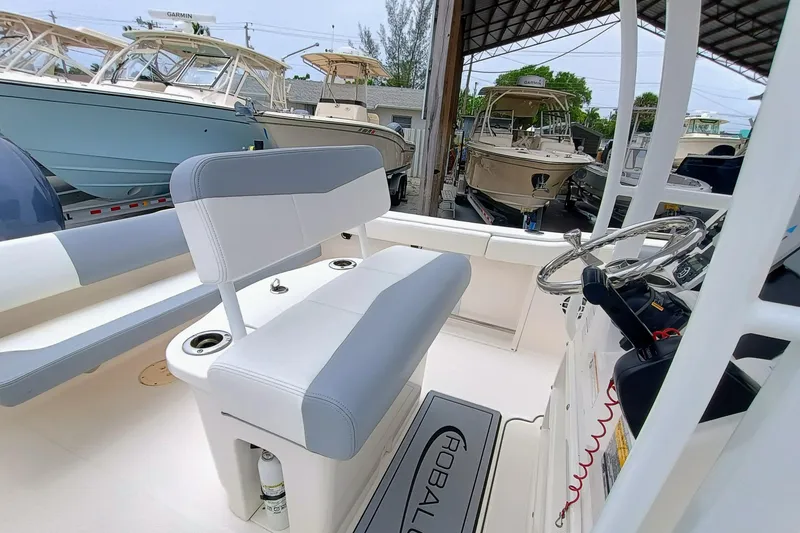Slide: The Image of 2023 Robalo R222 Center Console boat interior with seating and steering wheel. - 10