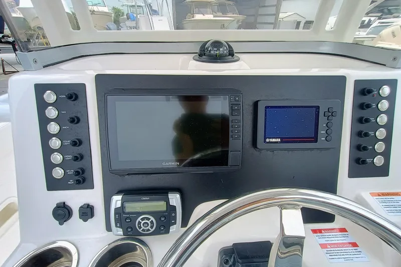 Slide: The Image of 2023 Robalo R222 Center Console dashboard with Garmin and Yamaha displays. - 12
