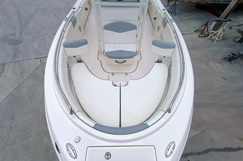 Slide: The Image of 2023 Robalo R222 Center Console boat interior with cushioned seating and storage. - 19