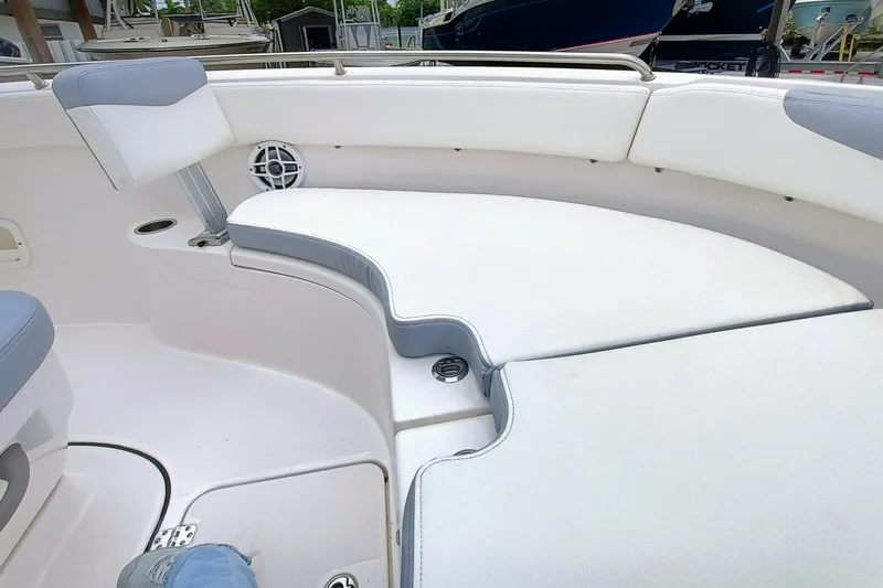 Slide: The Image of 2023 Robalo R222 Center Console boat interior with cushioned seating and cup holder. - 20