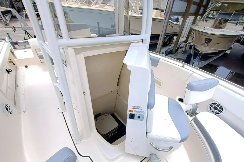 Slide: The Image of 2023 Robalo R222 Center Console boat interior with seating and storage area. - 24