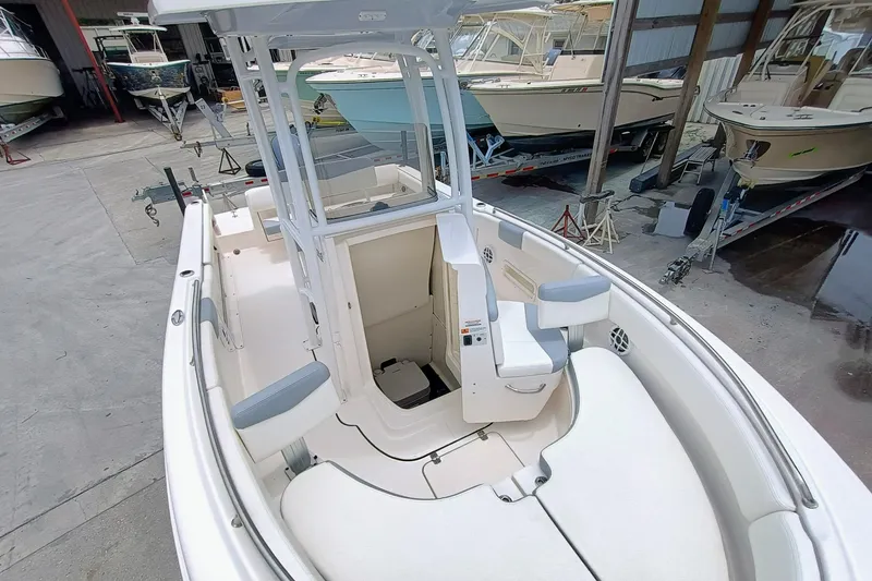 Slide: The Image of 2023 Robalo R222 Center Console boat in storage, showcasing seating and console design. - 25