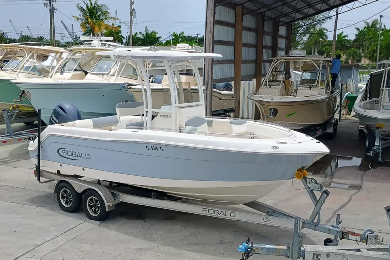Slide: The Image of 2023 Robalo R222 Center Console boat on trailer in marina setting. - 5