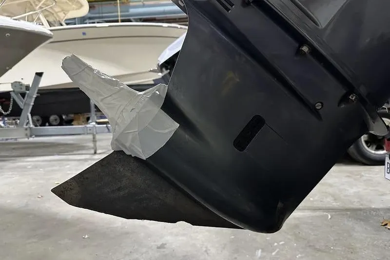 Slide: The Image of 2018 Robalo R242 Explorer boat on trailer, showing rear view and license plate. - 11