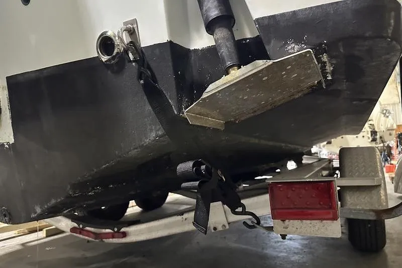 Slide: The Image of 2018 Robalo R242 Explorer boat on trailer, showing rear view with license plate. - 13