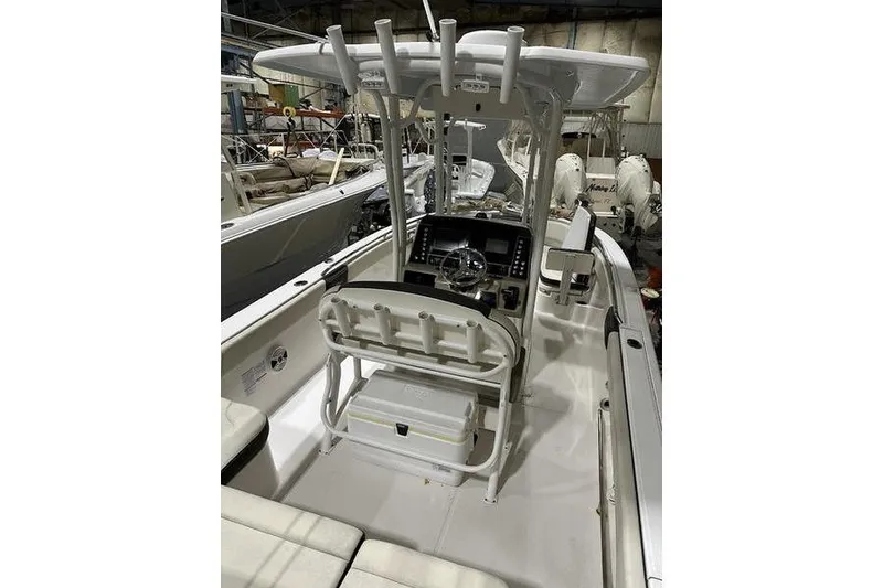 Slide: The Image of 2018 Robalo R242 Explorer boat dashboard with steering wheel and control panel. - 16