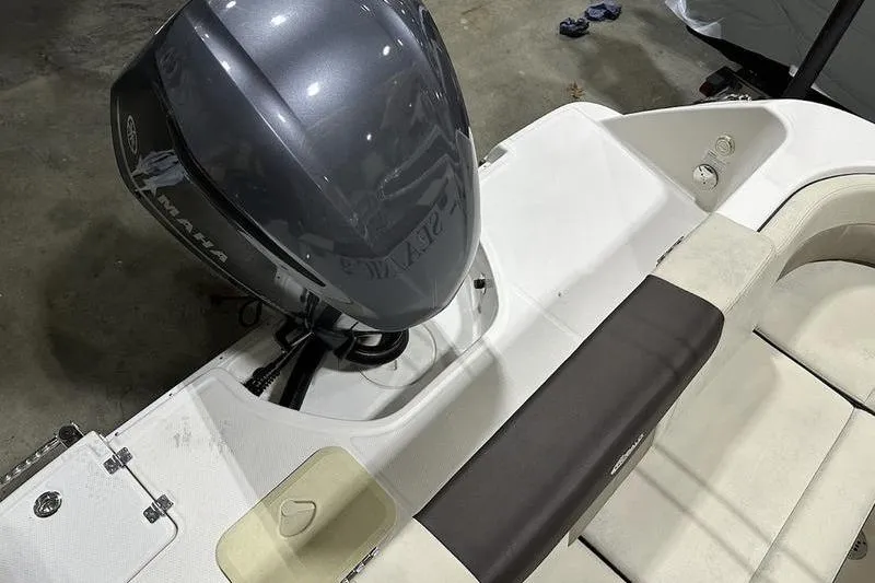 Slide: The Image of 2018 Robalo R242 Explorer boat interior with cushioned seating and storage compartments. - 18