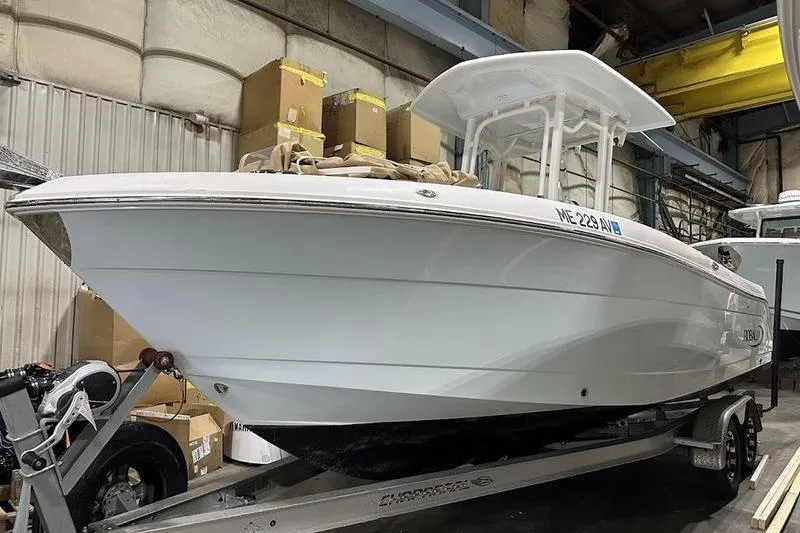 Slide: The Image of 2018 Robalo R242 Explorer boat on a Chaparral trailer in a garage. - 2