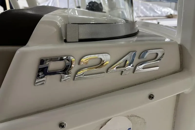 Slide: The Image of 2018 Robalo R242 Explorer boat T-top with rod holders and lighting fixtures. - 21