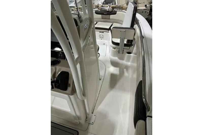 Slide: The Image of 2018 Robalo R242 Explorer boat interior with beige seating and storage compartments. - 23