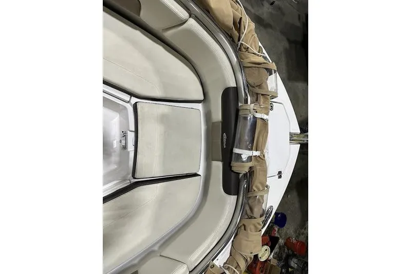 Slide: The Image of 2018 Robalo R242 Explorer boat interior with cushioned seating and storage compartments. - 24