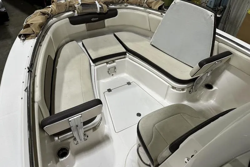 Slide: The Image of 2018 Robalo R242 Explorer boat interior with cushioned seating and storage compartments. - 25