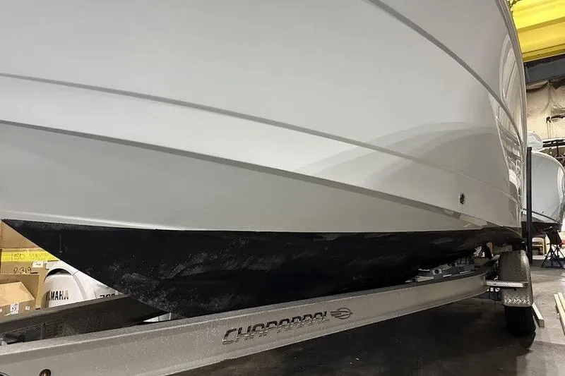 Slide: The Image of 2018 Robalo R242 Explorer boat with Yamaha engine in a warehouse setting. - 3