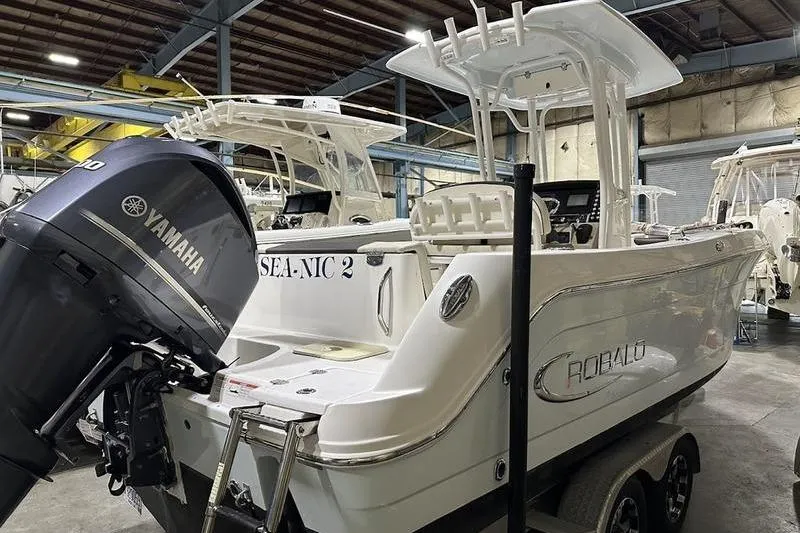 Slide: The Image of 2018 Robalo R242 Explorer boat on trailer in indoor storage facility. - 4