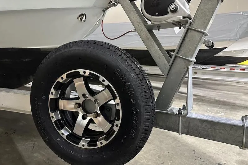 Slide: The Image of 2018 Robalo R242 Explorer boat on trailer in indoor storage facility. - 9