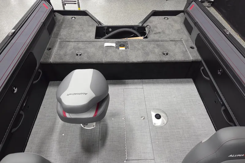 Slide: The Image of 2025 Alumacraft Trophy 185X Sport boat interior with seating and storage compartments. - 10