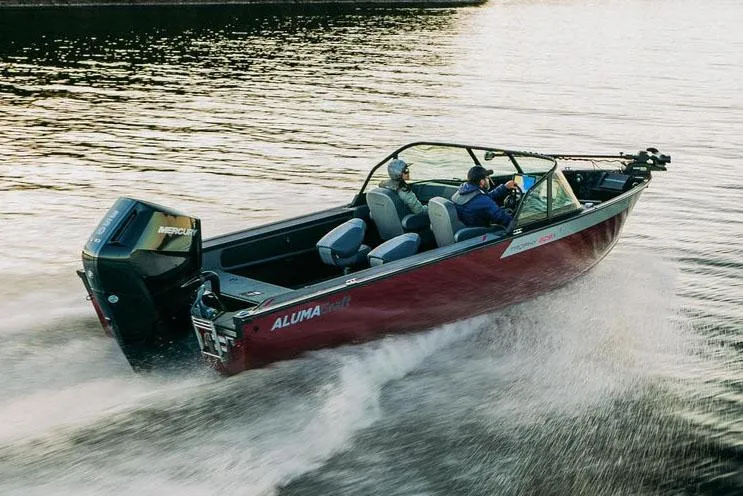 Slide: The Image of 2025 Alumacraft Trophy 185X Sport boat in showroom, red exterior, on trailer. - 2