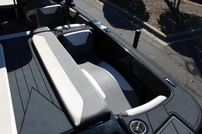 Slide: The Image of 2019 Heyday WTSurf boat interior with cushioned seating and cup holders. - 13
