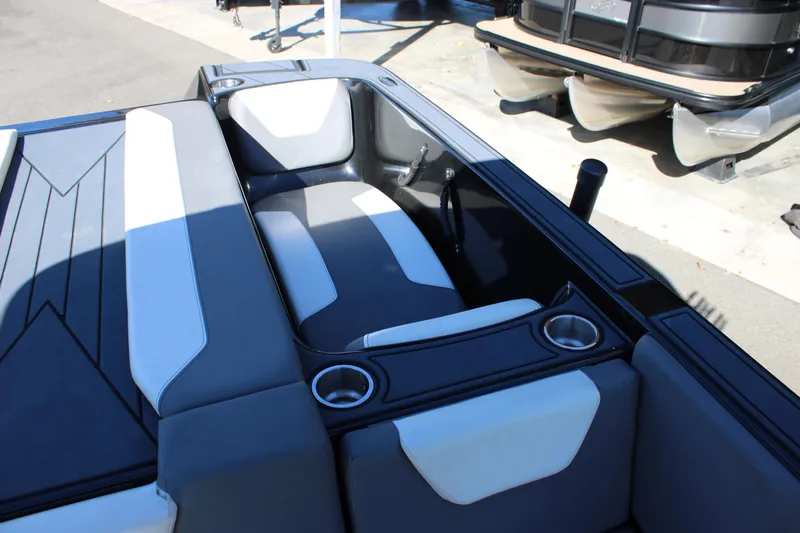 Slide: The Image of 2019 Heyday WTSurf boat interior with gray and white seating and cup holders. - 25