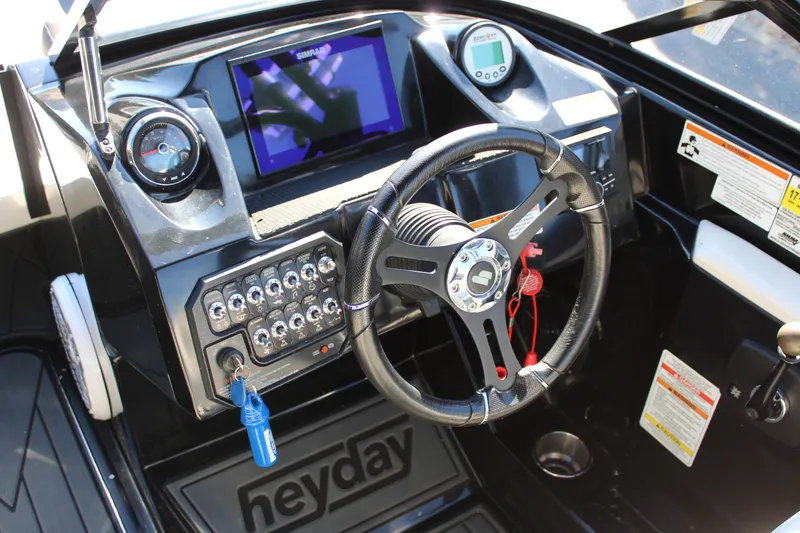 Slide: The Image of 2019 Heyday WTSurf boat dashboard with steering wheel and control panel. - 30