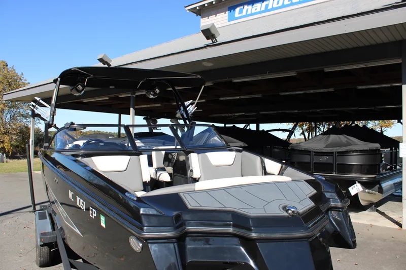 Slide: The Image of 2019 Heyday WTSurf boat in a marina, showcasing sleek design and modern features. - 11