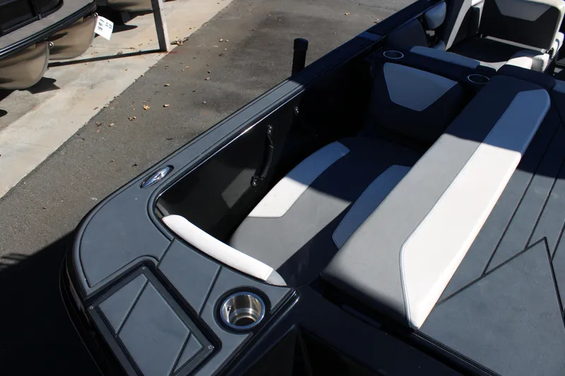 Slide: The Image of 2019 Heyday WTSurf boat interior with gray and white seating, cup holders, and sleek design. - 12