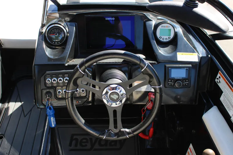 Slide: The Image of 2019 Heyday WTSurf boat dashboard with steering wheel and control panel. - 27