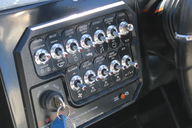 Slide: The Image of Control panel of a 2019 Heyday WTSurf boat with various switches and key ignition. - 29