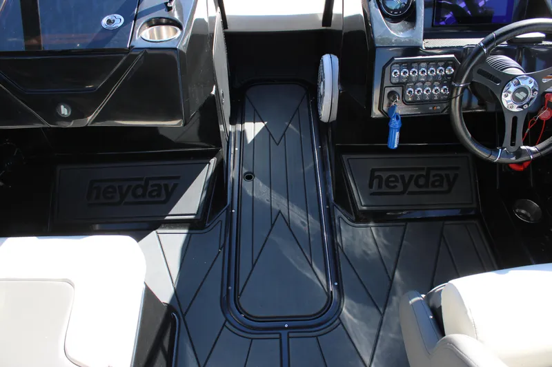 Slide: The Image of 2019 Heyday WTSurf boat interior with steering wheel and control panel. - 32