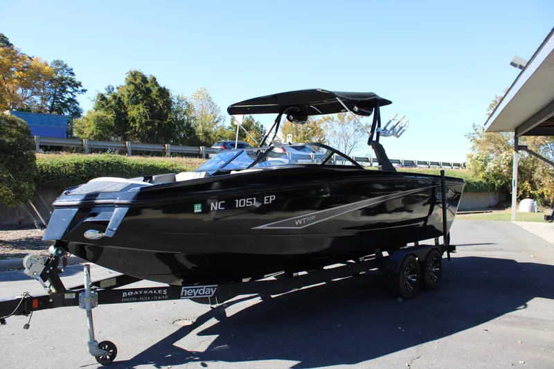 Slide: The Image of 2019 Heyday WTSurf boat on trailer, black exterior, parked outdoors. - 4