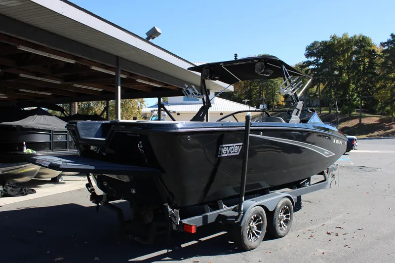 Slide: The Image of 2019 Heyday WTSurf boat on trailer, parked outdoors under a shelter. - 6