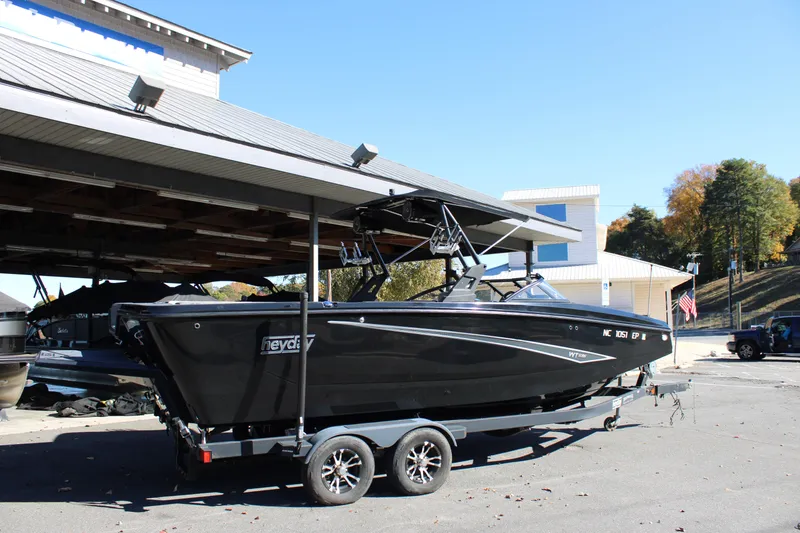 Slide: The Image of 2019 Heyday WTSurf boat on trailer, parked outdoors near a building. - 7