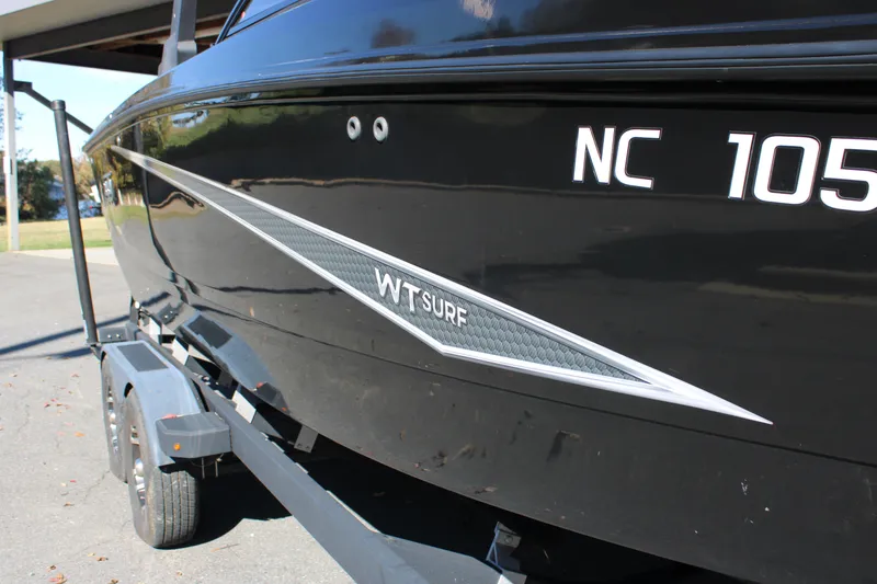 Slide: The Image of 2019 Heyday WTSurf boat on trailer, black exterior with NC registration. - 9