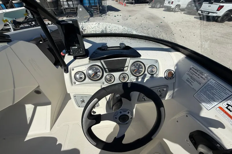 Slide: The Image of 2016 Tahoe 550TF boat dashboard with steering wheel and navigation equipment. - 12