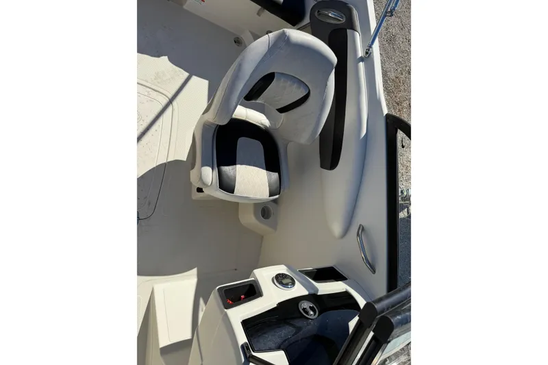 Slide: The Image of Interior of a 2016 Tahoe 550TF boat featuring a cushioned seat and control panel. - 14