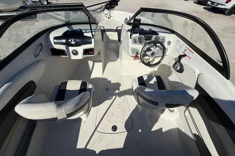 Slide: The Image of Interior of a 2016 Tahoe 550TF boat, featuring dual seats and a modern dashboard. - 7