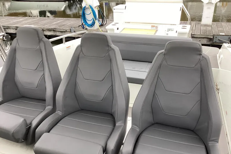 Slide: The Image of Three sleek gray seats on 2024 Quarken 27 T-Top V2 boat. - 11