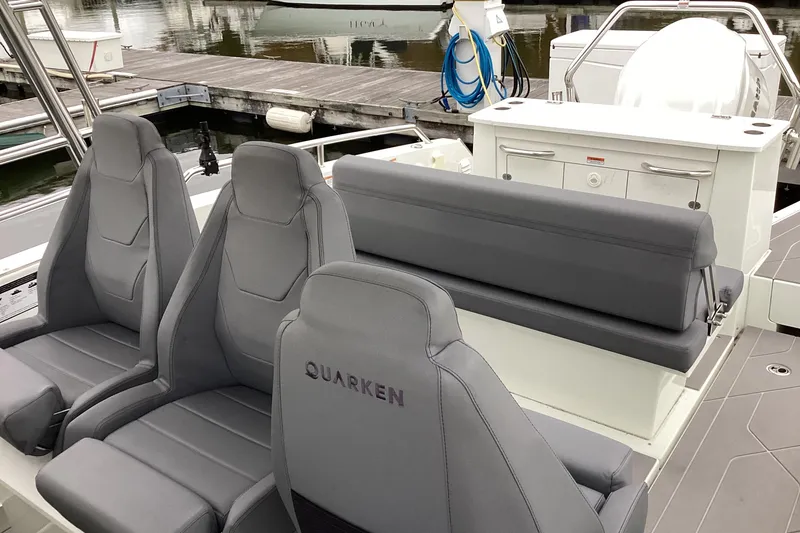 Slide: The Image of 2024 Quarken 27 T-Top V2 boat interior with gray seating and modern design. - 15