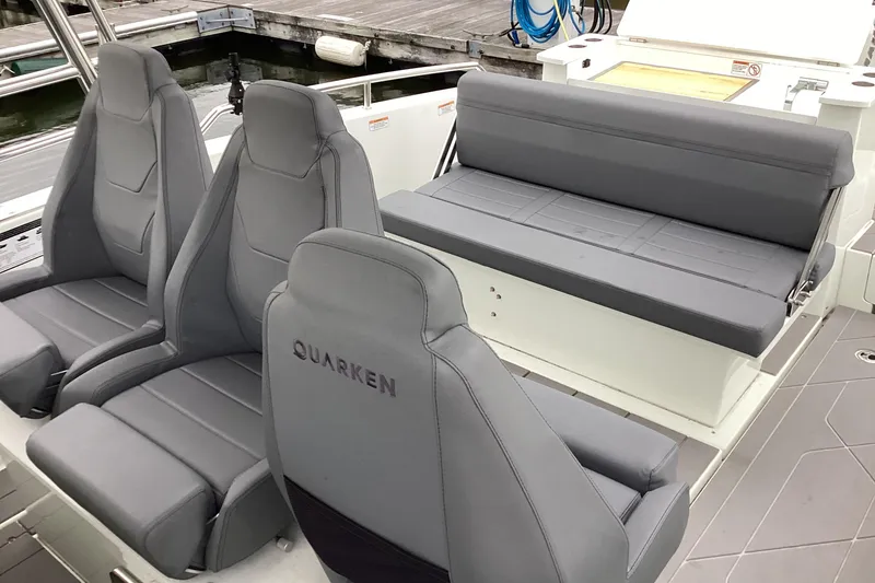 Slide: The Image of 2024 Quarken 27 T-Top V2 boat interior with gray seating and modern design. - 19
