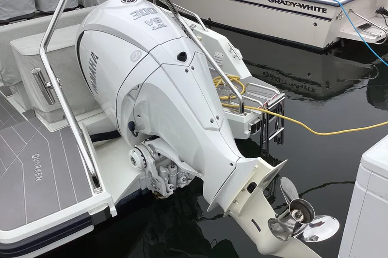 Slide: The Image of 2024 Quarken 27 T-Top V2 with Yamaha 300 V6 outboard engine at dock. - 2