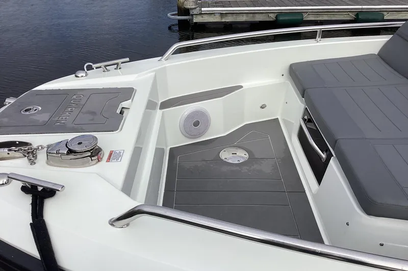 Slide: The Image of 2024 Quarken 27 T-Top V2 boat interior with seating and deck details. - 25