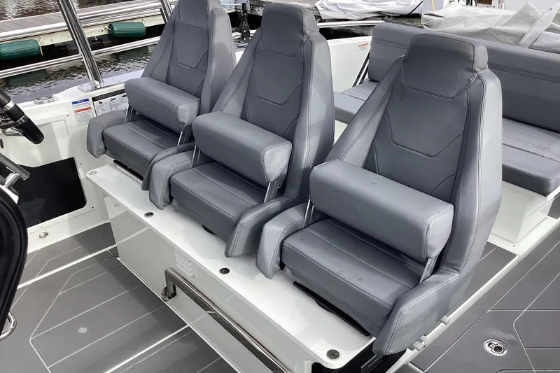 Slide: The Image of 2024 Quarken 27 T-Top V2 boat interior with three sleek, gray seats. - 26