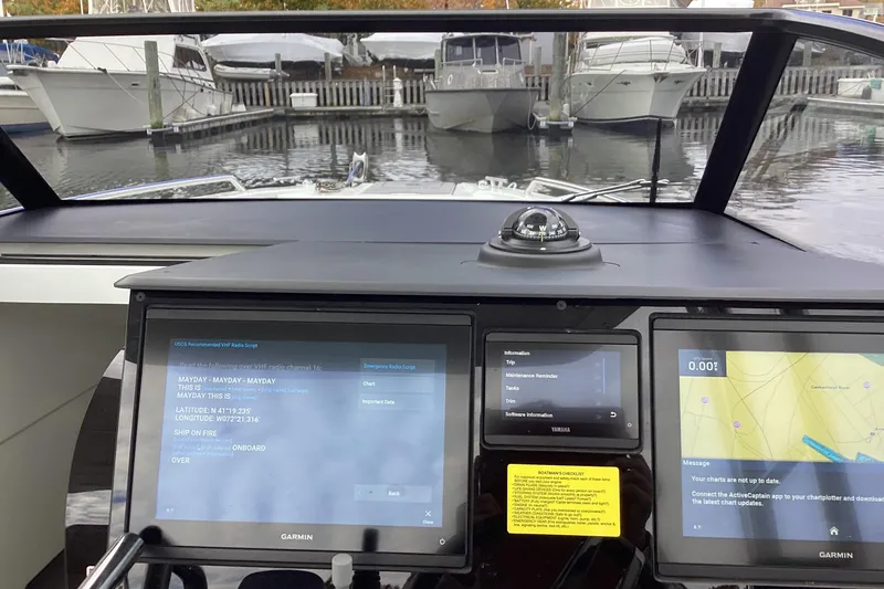 Slide: The Image of Cockpit view of 2024 Quarken 27 T-Top V2 with navigation screens and compass. - 29