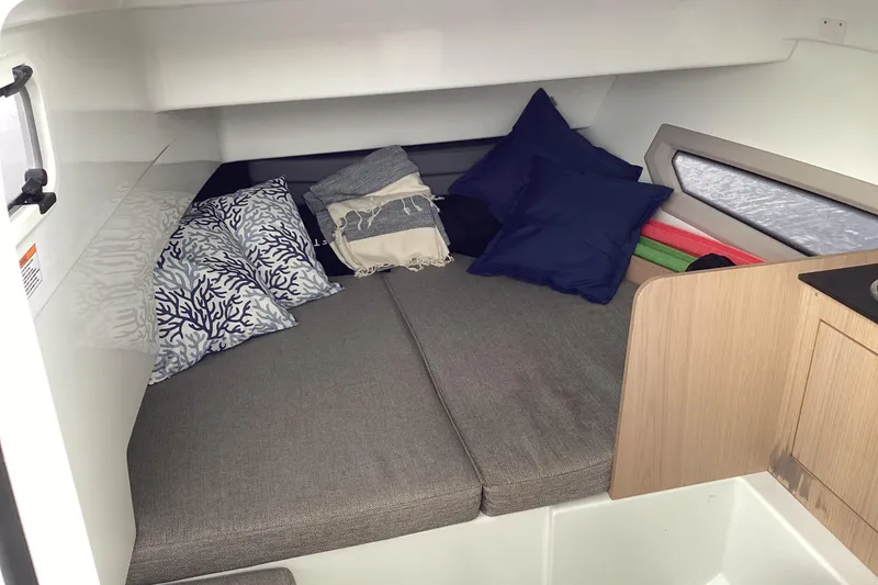 Slide: The Image of Cozy cabin interior of 2024 Quarken 27 T-Top V2 with cushions and pillows. - 31