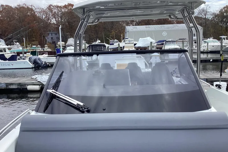 Slide: The Image of 2024 Quarken 27 T-Top V2 boat docked at marina, front view. - 34