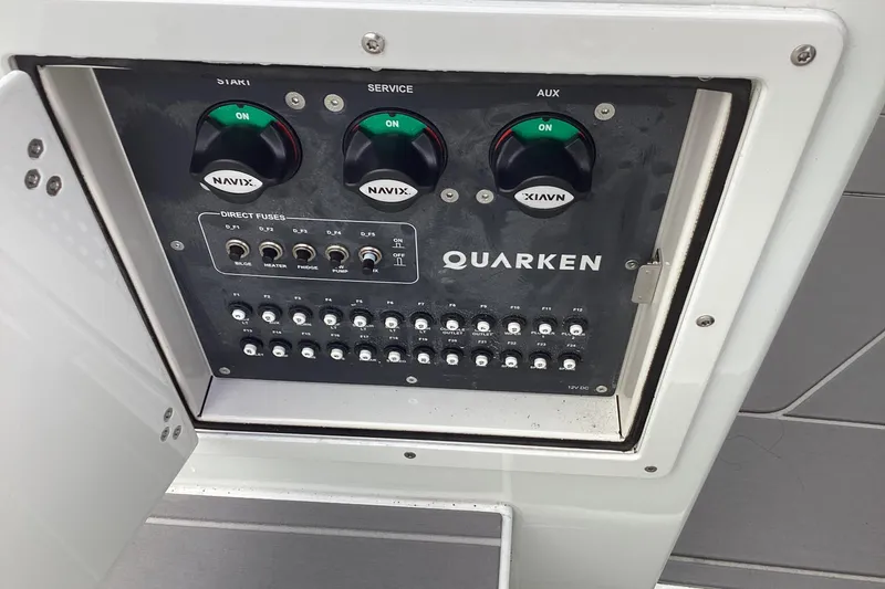 Slide: The Image of Control panel of 2024 Quarken 27 T-Top V2 boat with switches and fuses. - 35
