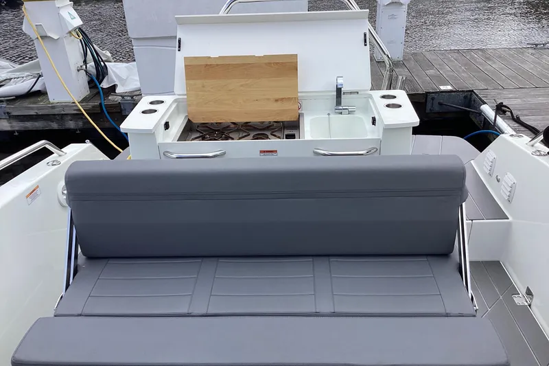 Slide: The Image of 2024 Quarken 27 T-Top V2 boat interior with seating and kitchenette. - 37